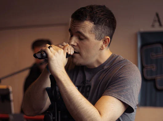 Close up of Joe Scovill from Smoove Series singing close to the microphone with eyes closed at Two Roads Brewing in Straford, CT