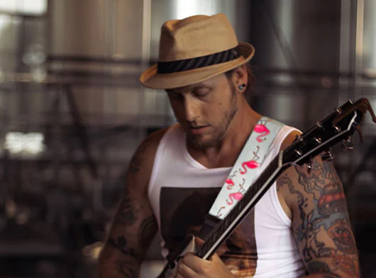 Close up of Mike Angeli playing guitar with him turned on an angle at Two Roads Brewing at Stratford, CT