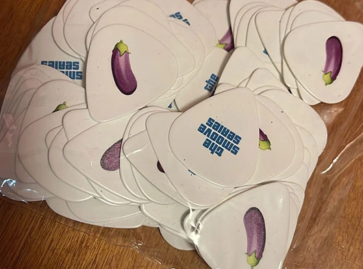Custom guitar picks with Eggplant Emoji for Smoove Series live performances